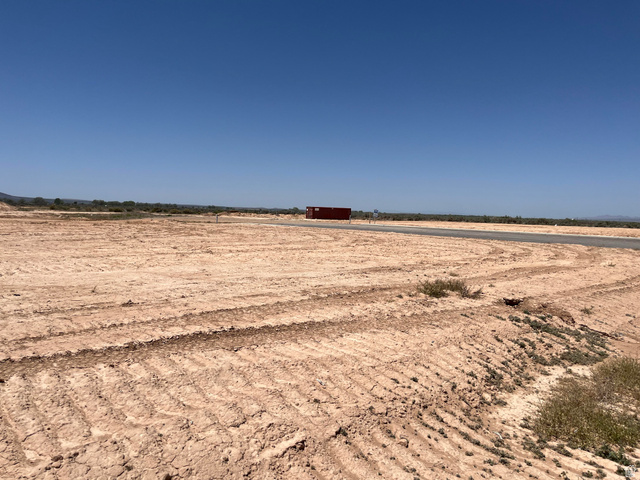 5183 North 75 East, Unit 213 Enoch, UT 84721 - Photo 2 of 12 Expansive cleared land parcel featuring a paved road frontage
