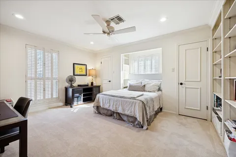 a spacious bedroom with a bed a couch and a desk in it