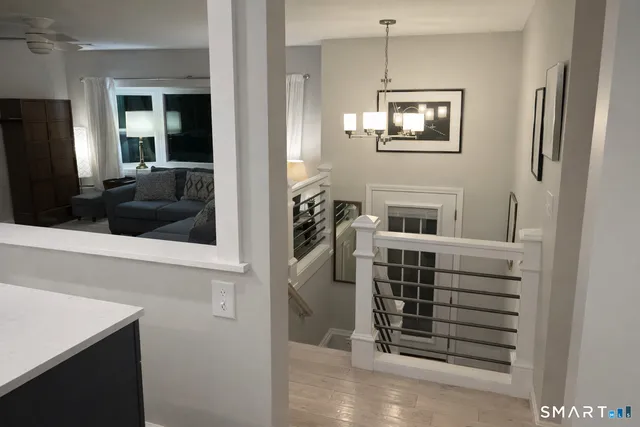 a view of a hallway with windows and cabinet