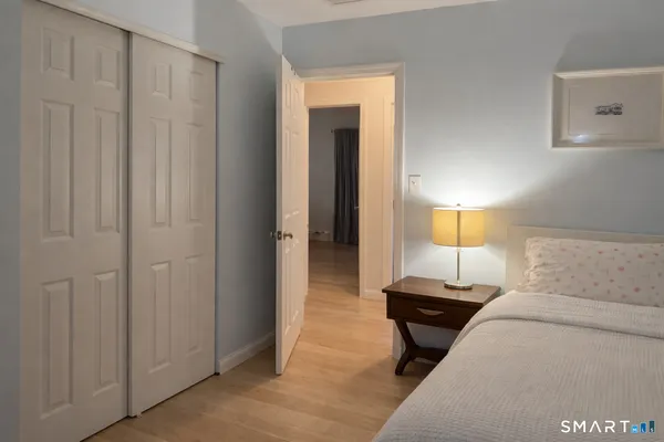 a bedroom with a bed and a lamp