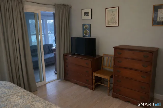 a bedroom with a bed and a lamp on table