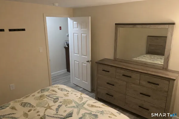 a bedroom with a bed and a dresser in it