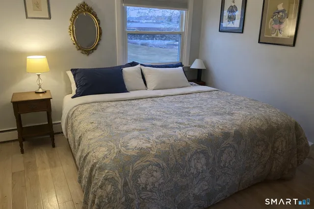 a bedroom with bed and window