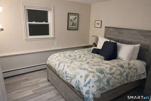 a bathroom with a bathtub and chair