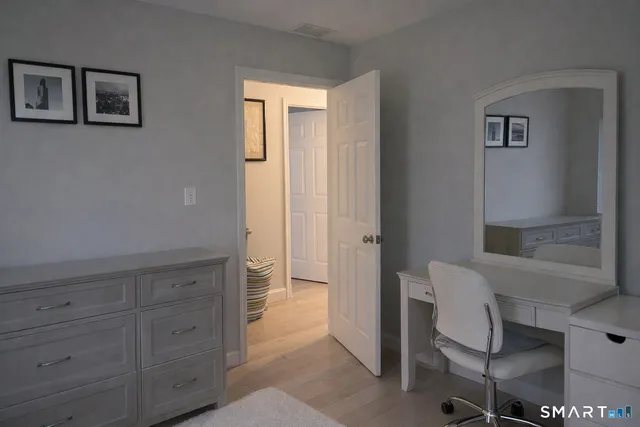 a bedroom with a bed and a lamp