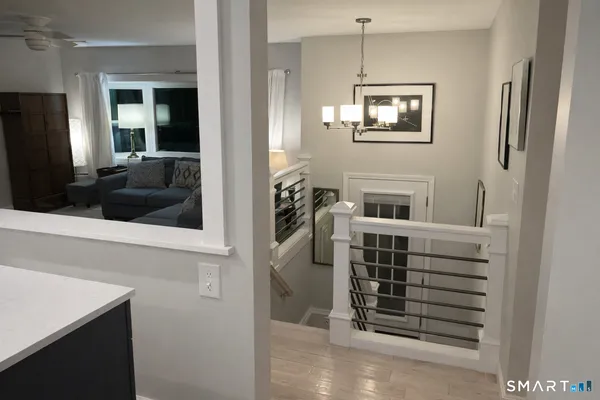 a view of a hallway with windows and cabinet