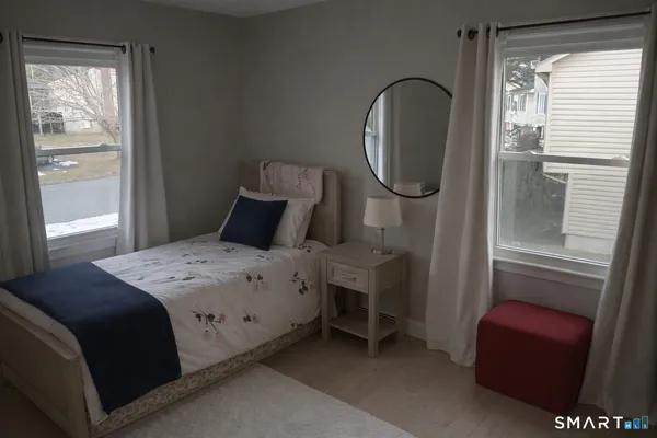 a bedroom with a bed and a mirror