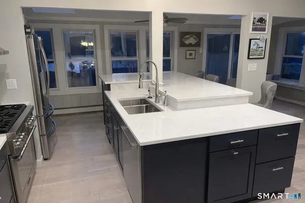 a kitchen with sink and refrigerator