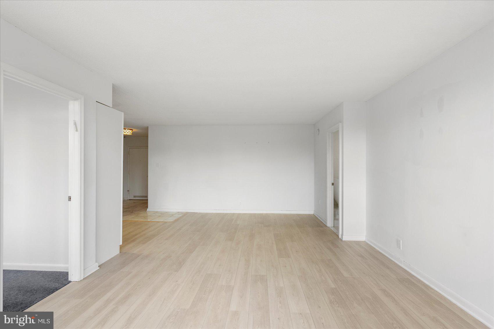 7111 Park Heights Avenue, Unit 305 Baltimore, MD 21215 - Photo 11 of 33 a view of an empty room and wooden floor