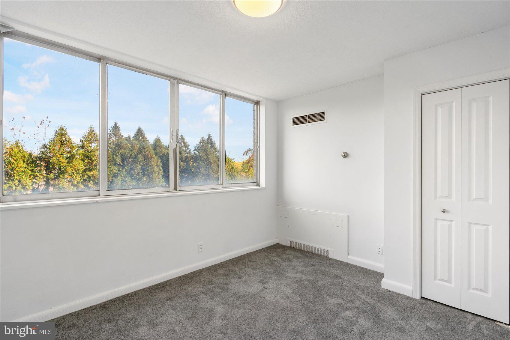 7111 Park Heights Avenue, Unit 305 Baltimore, MD 21215 - Photo 22 of 33 an empty room with windows and view of a balcony
