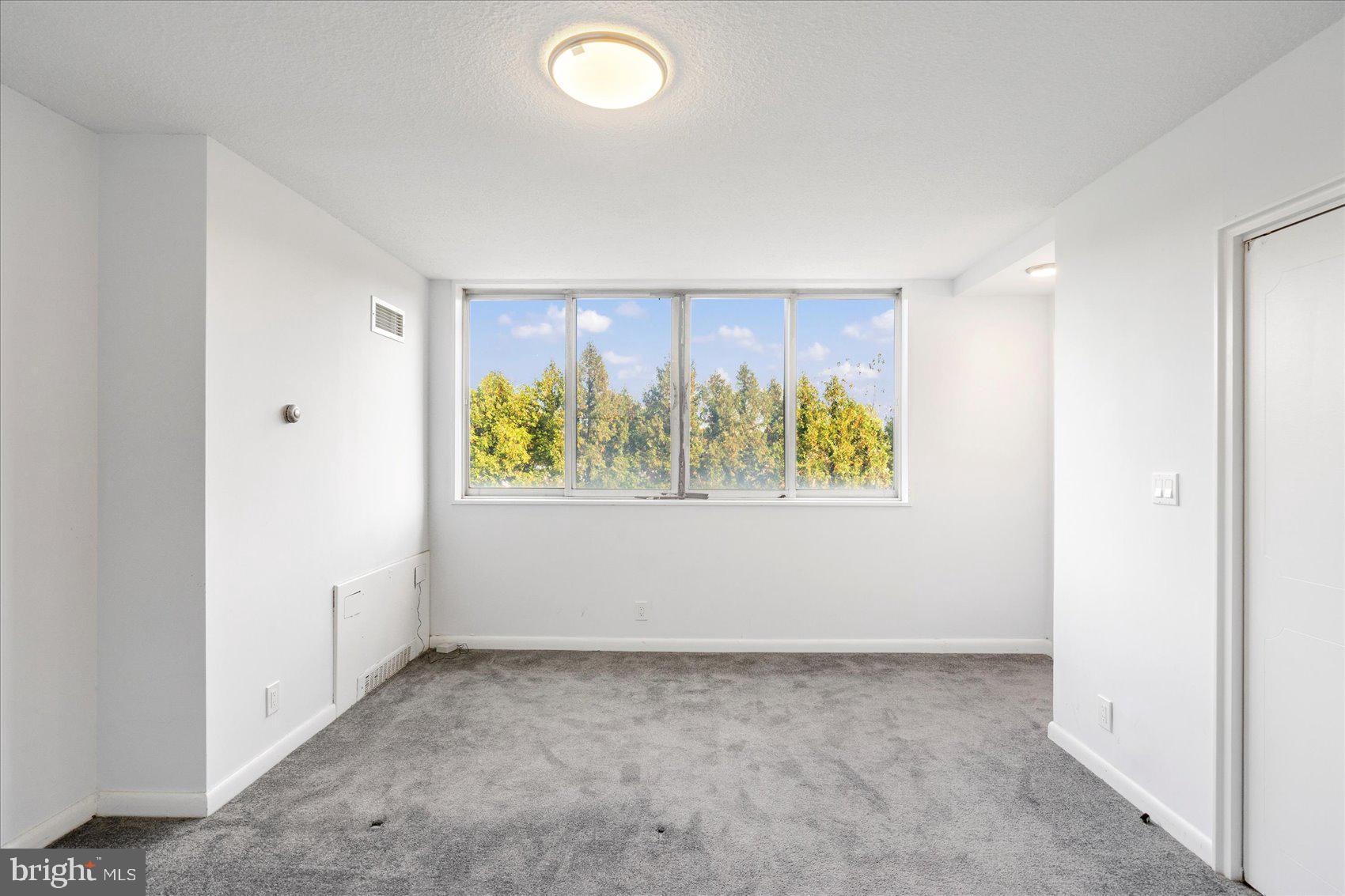 7111 Park Heights Avenue, Unit 305 Baltimore, MD 21215 - Photo 5 of 33 an empty room with windows