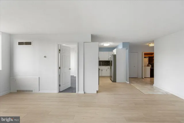 a view of an empty room and wooden floor