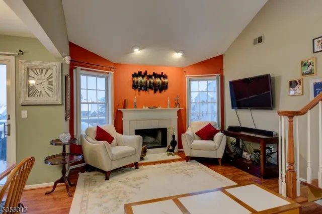 a living room with furniture fireplace and flat screen tv