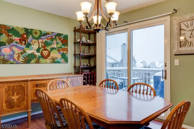 a view of a dining room with furniture wooden floor and chandelier