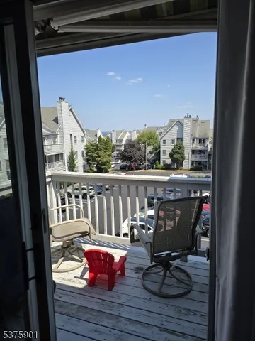 a view of balcony with couch and chairs