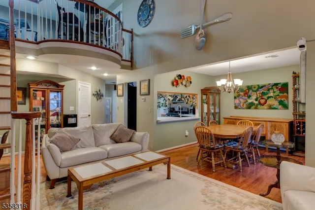 a living room with furniture and kitchen view