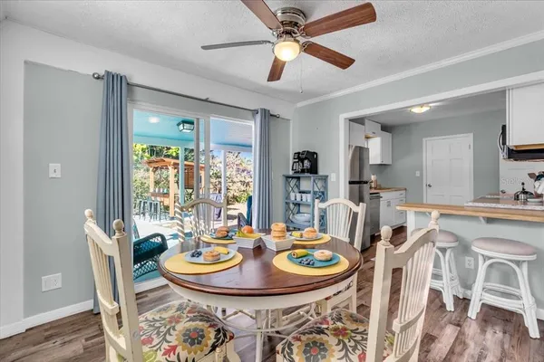 a dining room with furniture a rug and wooden floor