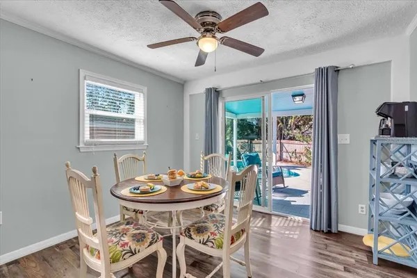 a view of a dining room with furniture and wooden floor