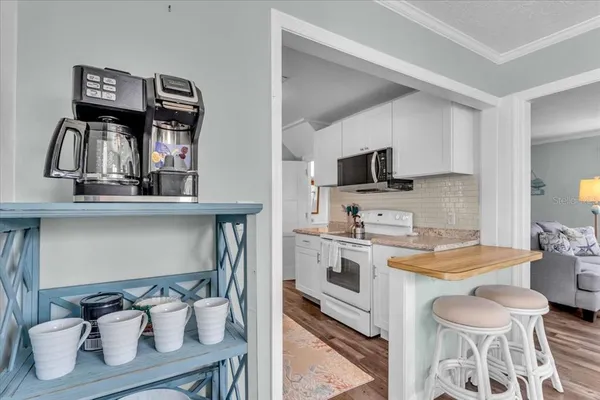 a kitchen with a sink appliances and cabinets