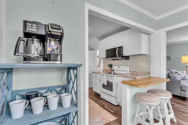 a kitchen with a sink appliances and cabinets