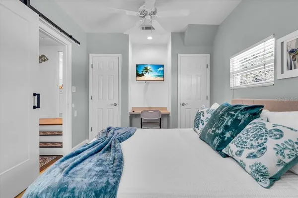 a bedroom with a bed and a chandelier