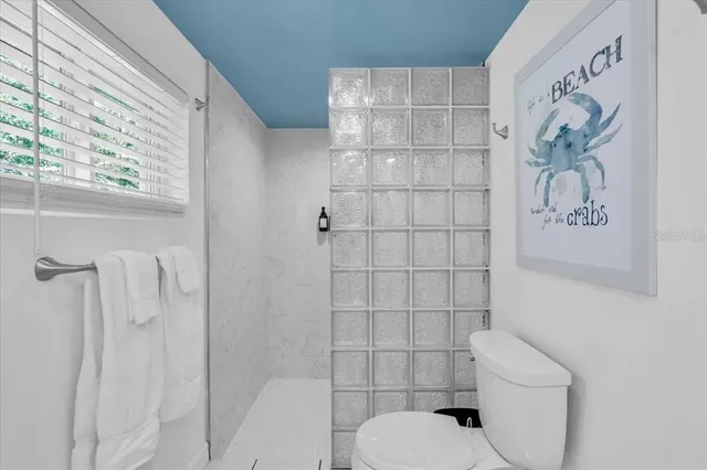 a bathroom with a toilet and shower