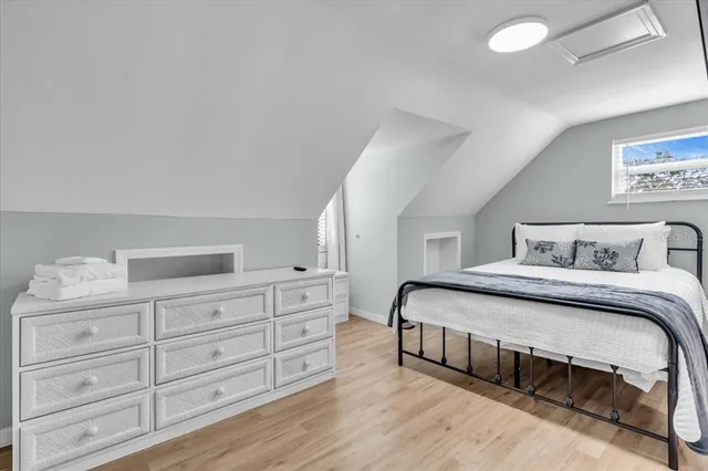 a bedroom with a large bed and a dresser