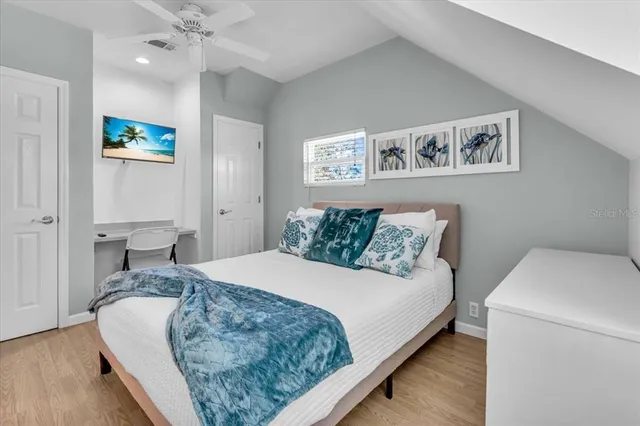 a bedroom with a bed and a table