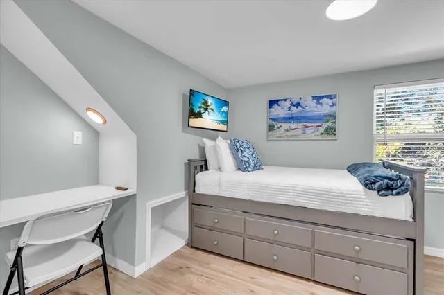 a bedroom with a bed and a painting on the wall