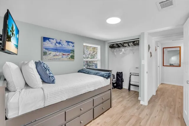 a bedroom with bed and cabinets