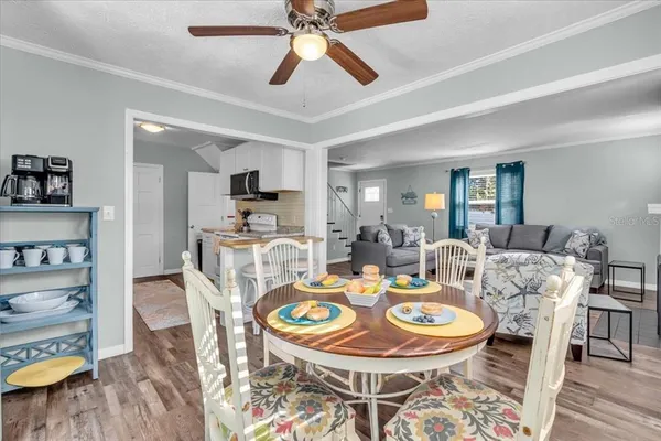 a dining room with furniture a rug and wooden floor