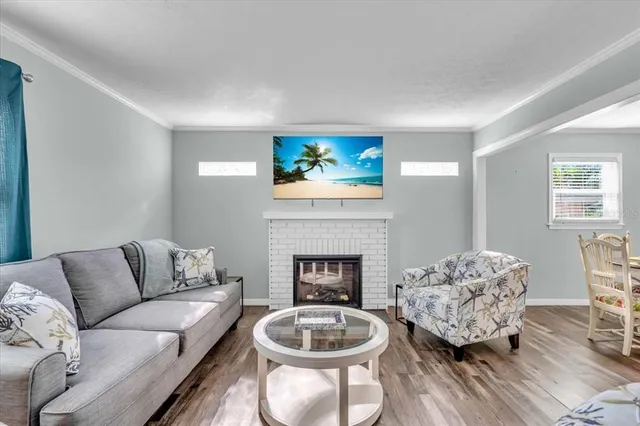 a living room with furniture a fireplace and a window