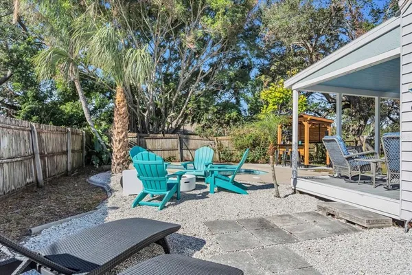 a view of backyard with deck and seating space
