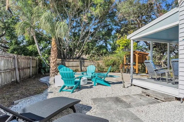 a view of backyard with deck and seating space