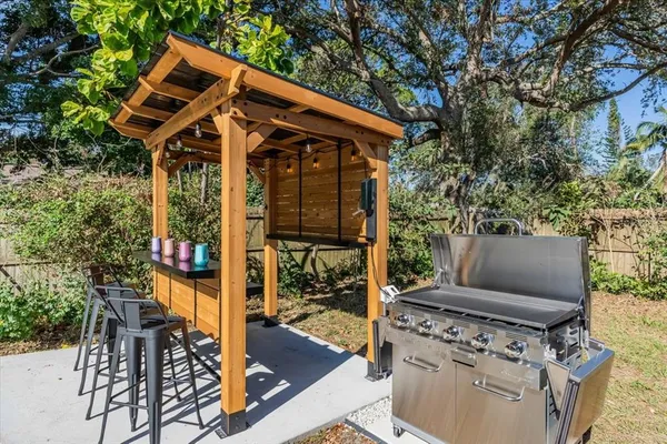 a view of a chairs and table in patio with potted plants