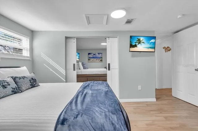 a bedroom with a bed and a view of kitchen