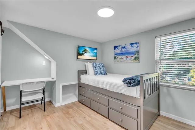 a bedroom with a bed and a desk