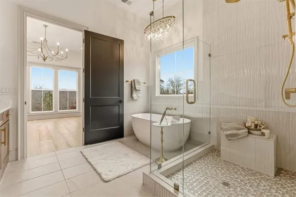 a en suite bathroom with a granite countertop sink mirror and double