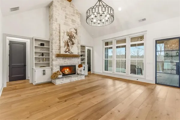 a large kitchen with kitchen island a stove a sink a center island and wooden floor