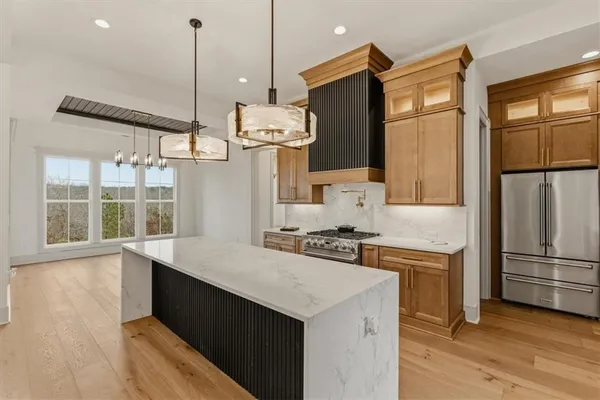a view of a living room kitchen and windows