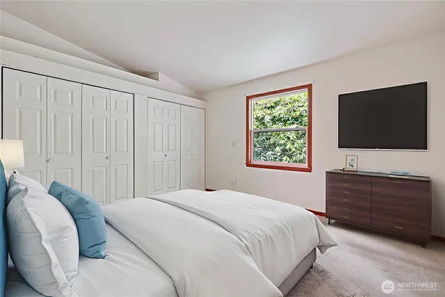 a bathroom with a granite countertop sink a toilet and a mirror