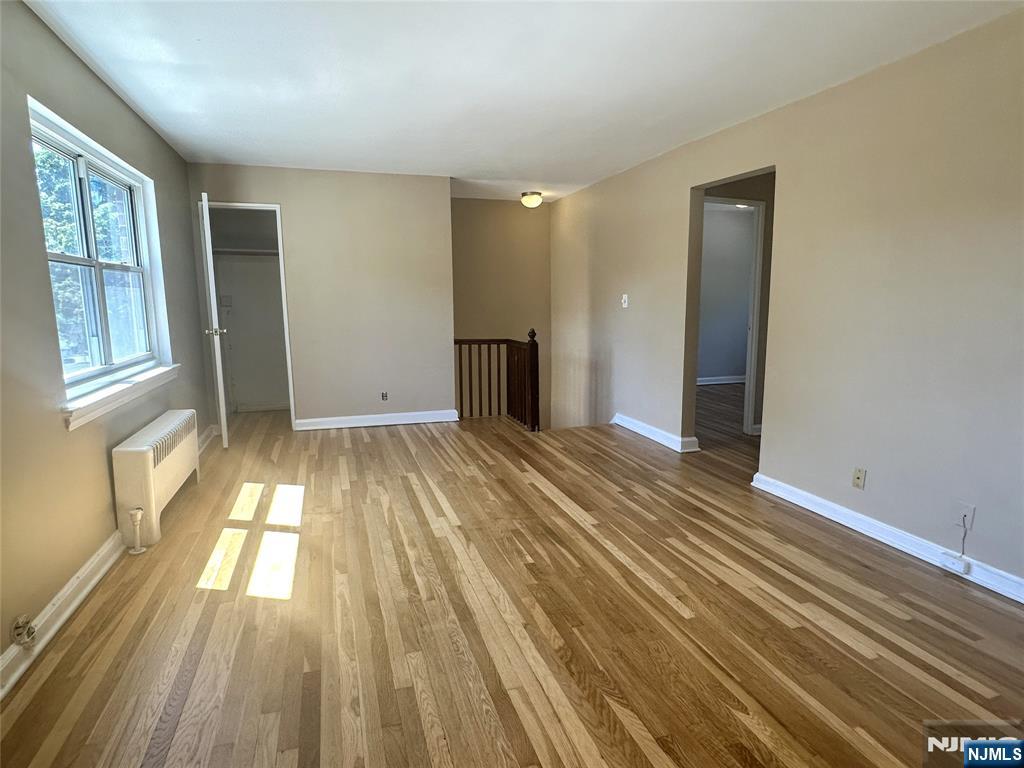 460 Heath Place, Unit 48 Hackensack, NJ 07601 - Photo 2 of 10 wooden floor in an empty room with a window