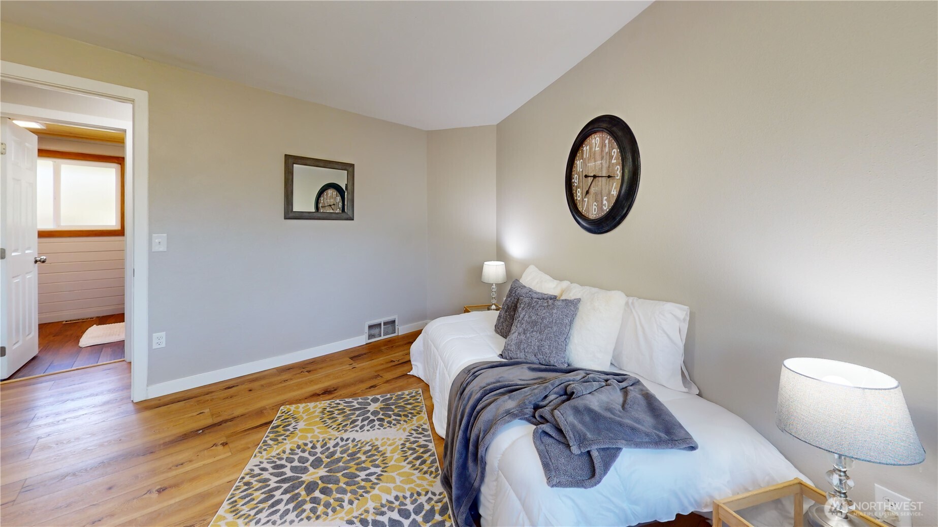 1305 336th Street South Roy, WA 98580 - Photo 18 of 40 a bed sitting in a bedroom next to a window and wooden floor
