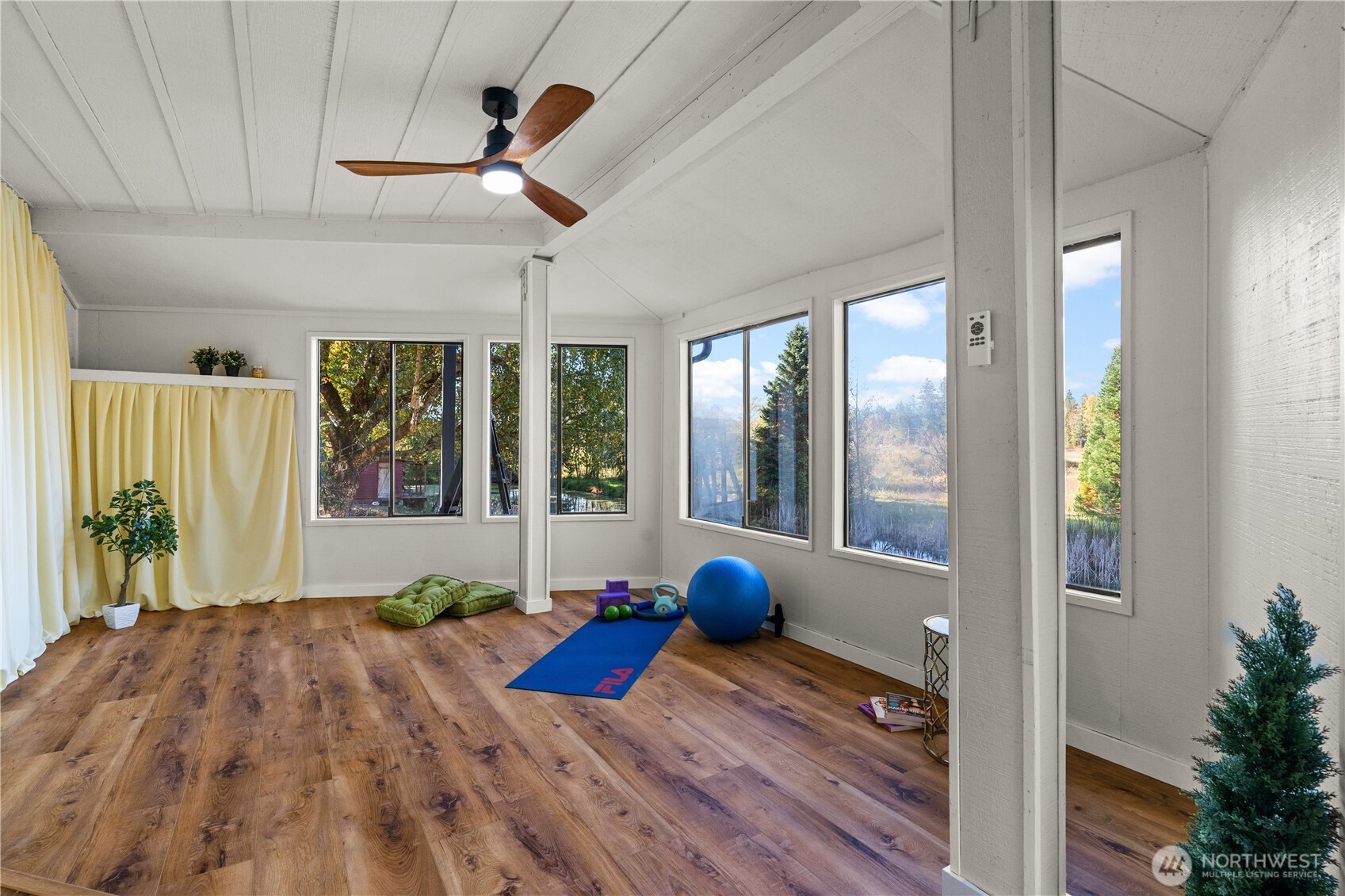 1305 336th Street South Roy, WA 98580 - Photo 22 of 40 a view of a livingroom with wooden floor and a large window