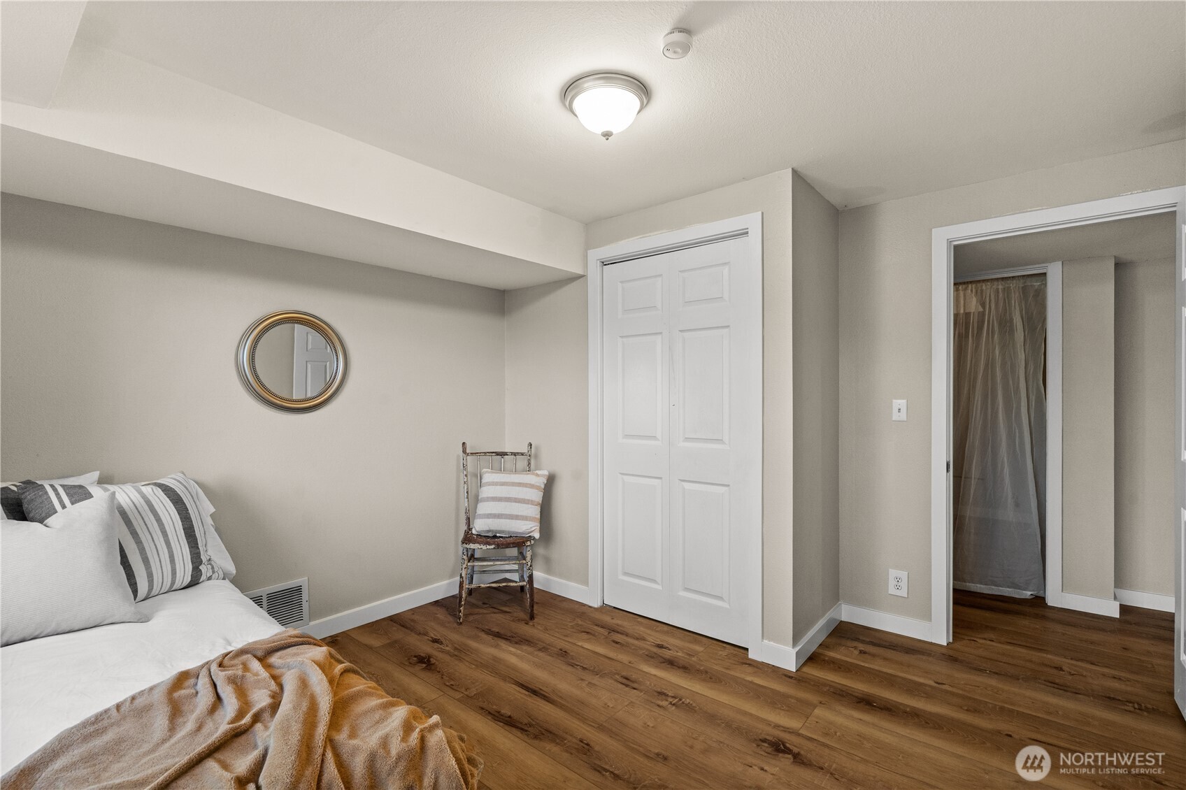 1305 336th Street South Roy, WA 98580 - Photo 26 of 40 a bedroom with a bed and a lamp on dresser