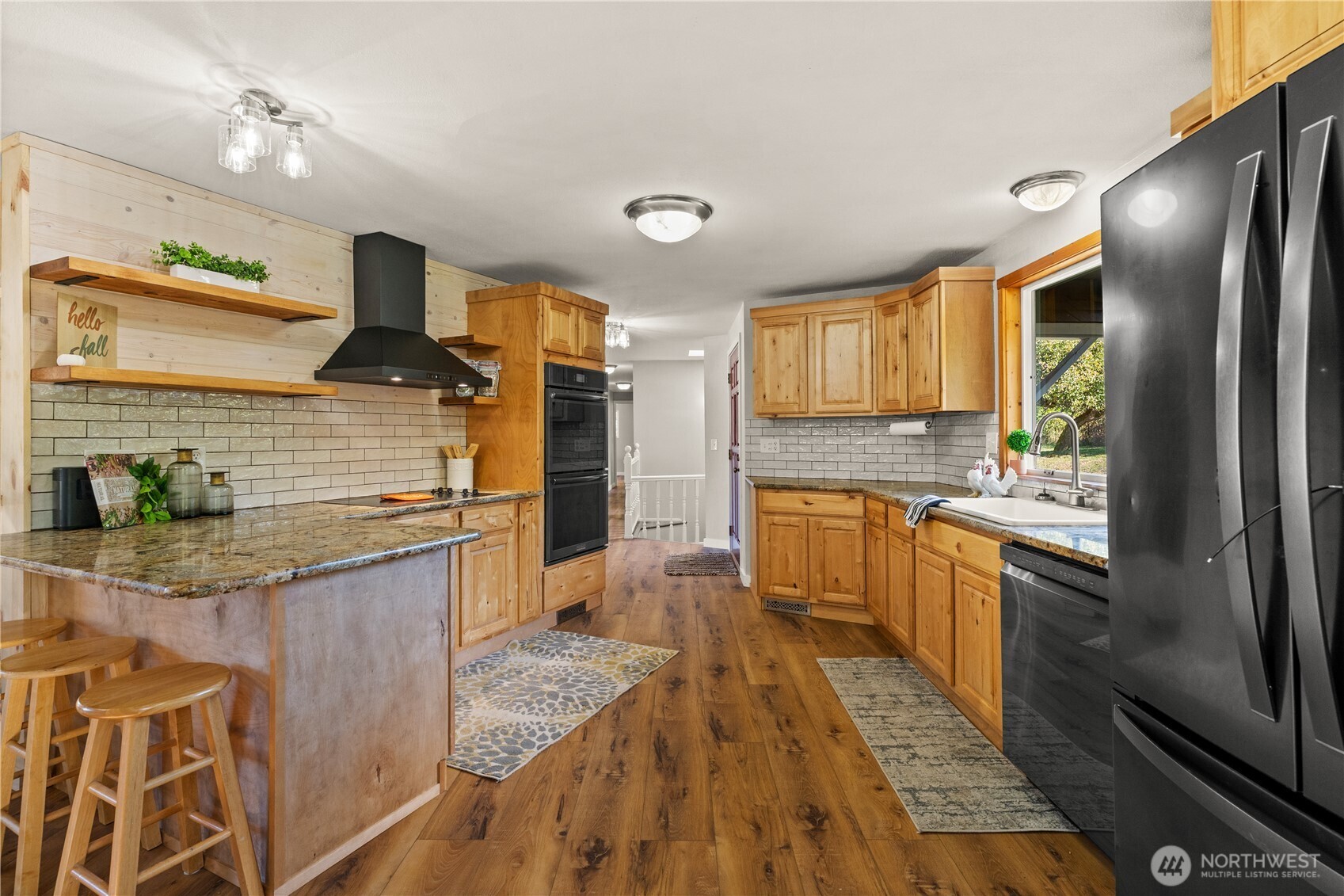 1305 336th Street South Roy, WA 98580 - Photo 7 of 40 a kitchen with stainless steel appliances granite countertop a sink a stove and a refrigerator