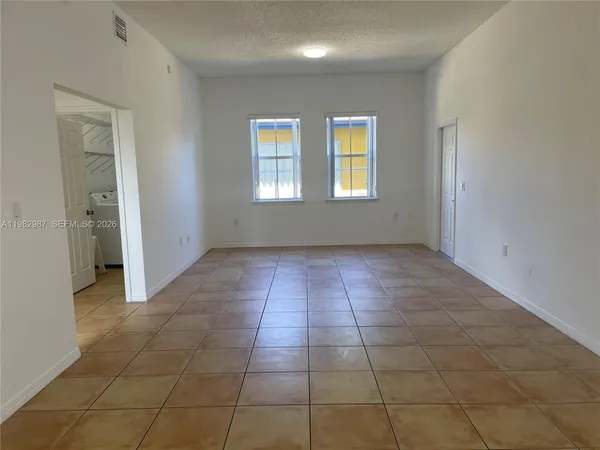 a view of an empty room with a window