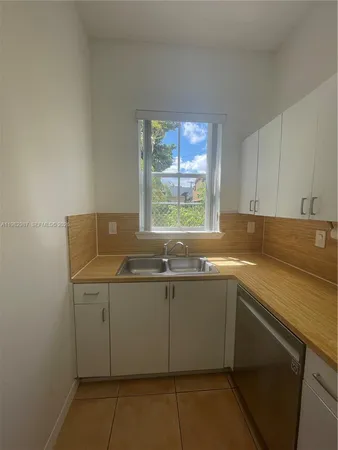 a kitchen with a sink and cabinets