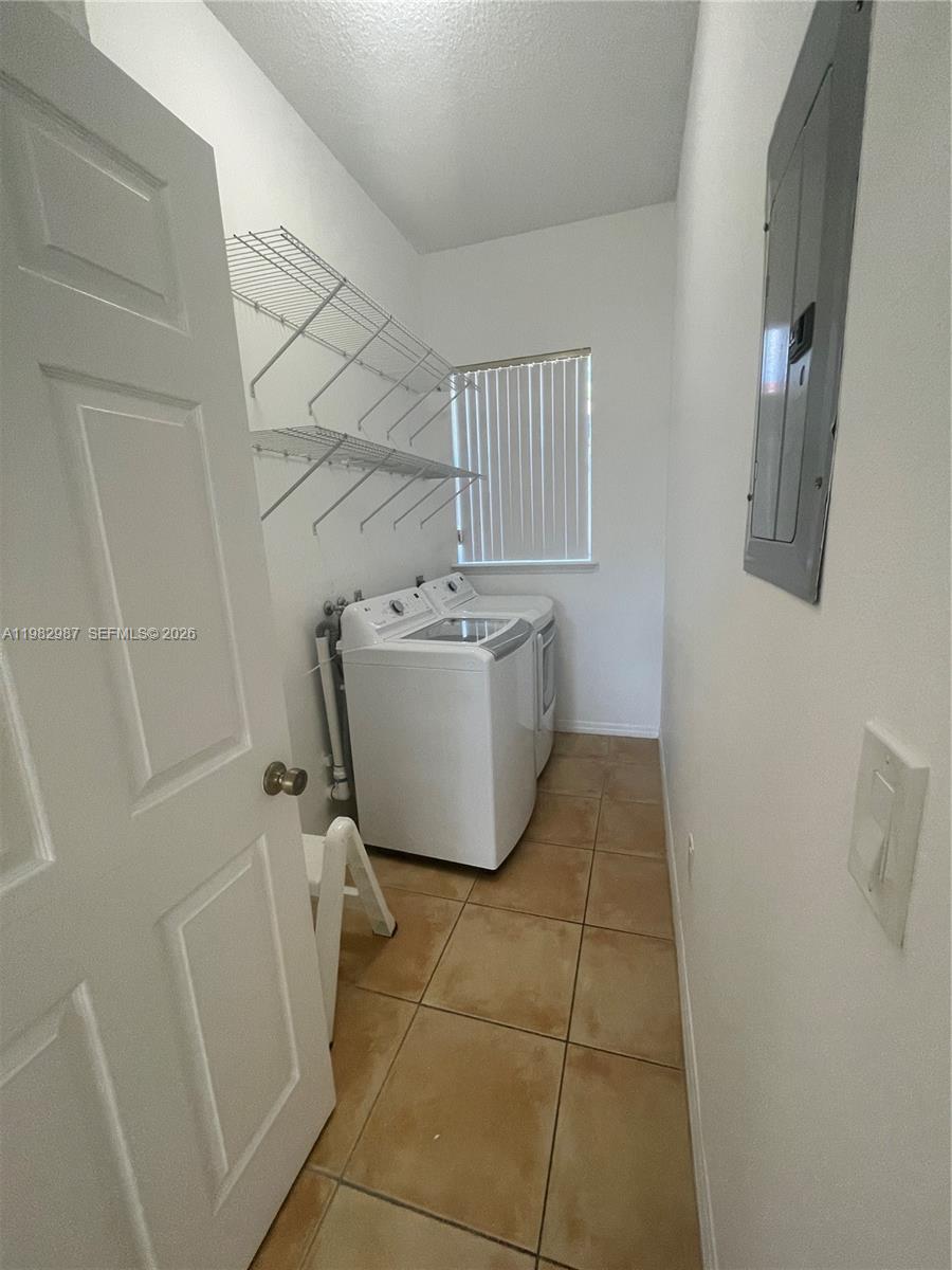 3421 Southwest 25th Street, Unit 1 Miami, FL 33133 - Photo 17 of 41 a room with a washer and dryer