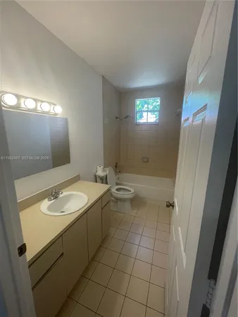 a bathroom with a toilet bathtub and sink